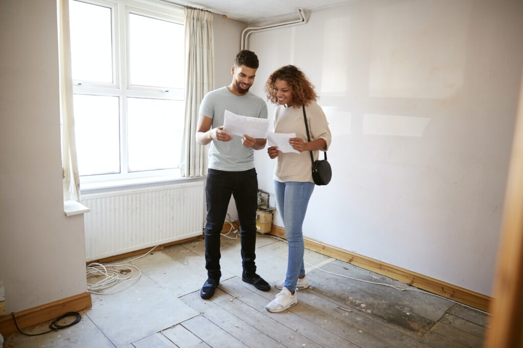 Get A New Year Promo for new Purchase couple buying house for first time looking at house survey in room to be renovated